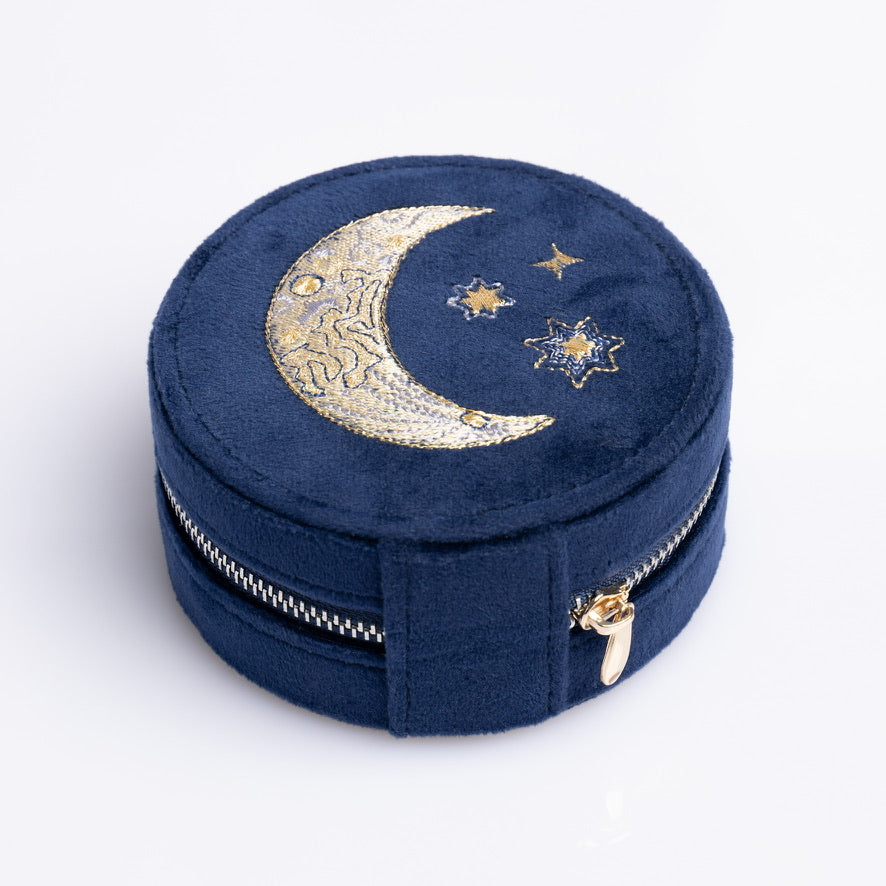 Round blue velvet mini travel jewelry box with embroidered moon and stars.
