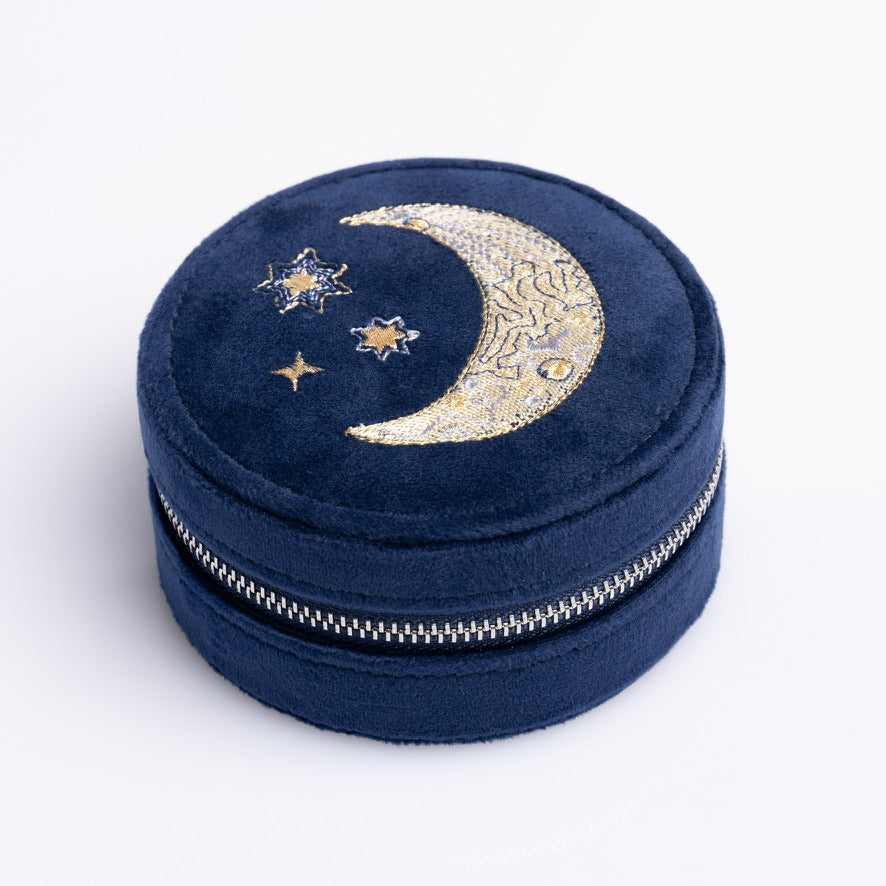 Round blue velvet mini travel jewelry box with embroidered moon and stars.