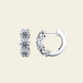 Pair of 3 stone diamond huggie gold earrings. 3-Stone Diamond Huggies. Solid gold and natural diamonds. Jewelry Dallas.