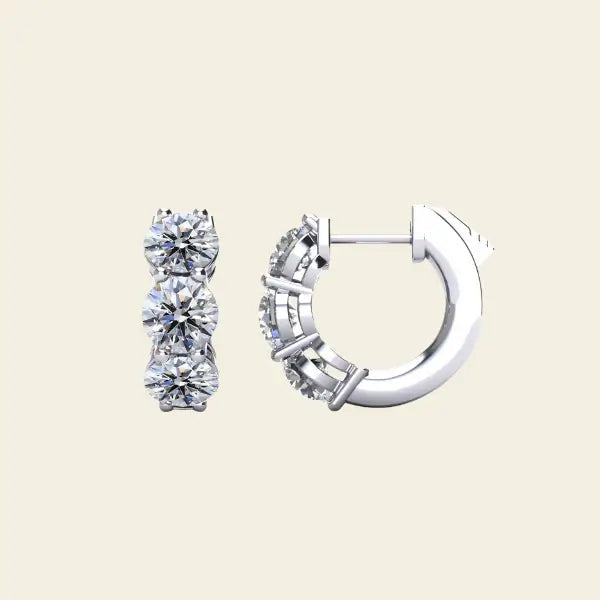Pair of 3 stone diamond huggie gold earrings. 3-Stone Diamond Huggies. Solid gold and natural diamonds. Jewelry Dallas.