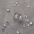 Pair of 3 stone diamond huggie gold earrings. 3-Stone Diamond Huggies. Solid gold and natural diamonds. Jewelry Dallas.