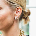 Diamond huggie earrings with baguette cut stones. 3-Stone Emerald Huggies. Solid gold and natural diamonds. Jewelry Dallas.