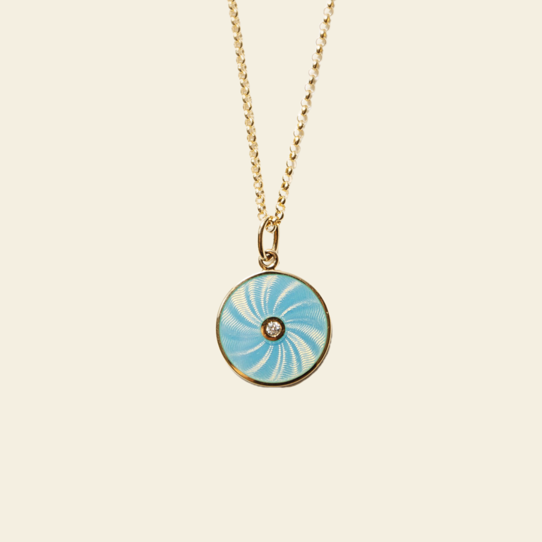 Necklace with a blue and gold pendant on a beige background