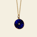 Necklace with a blue pendant on a beige background