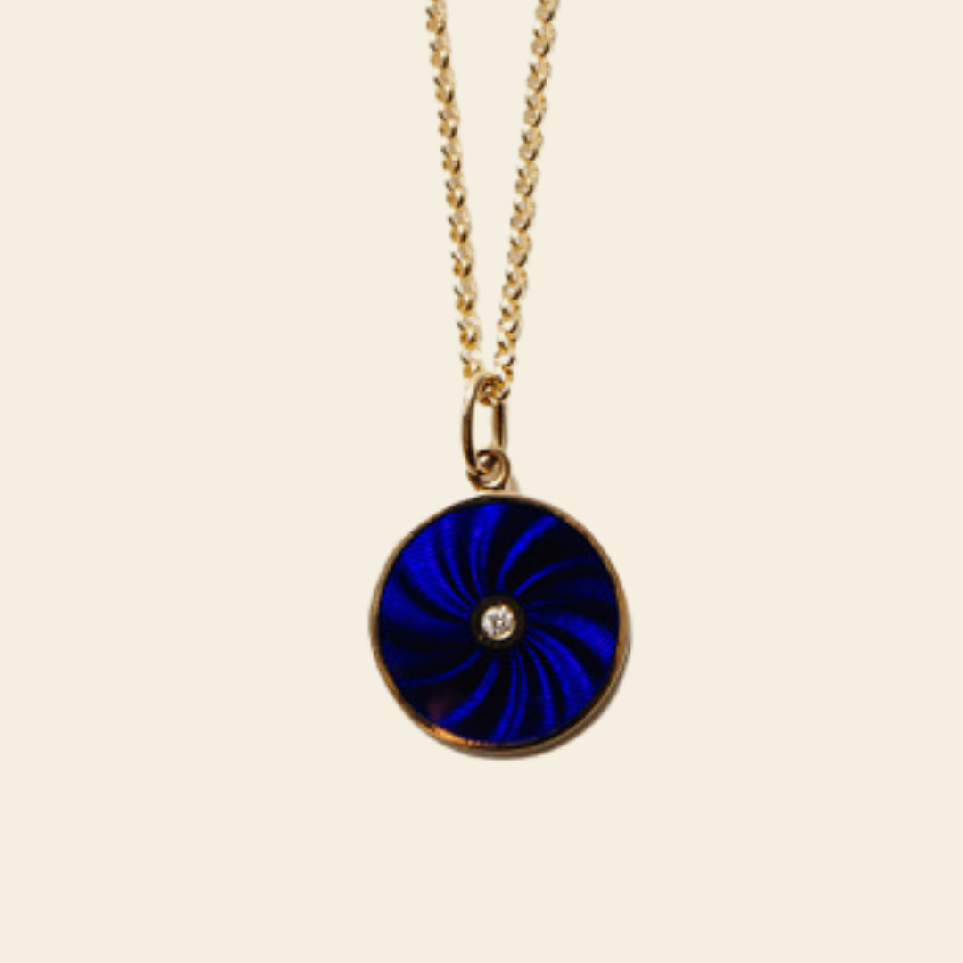 Necklace with a blue pendant on a beige background