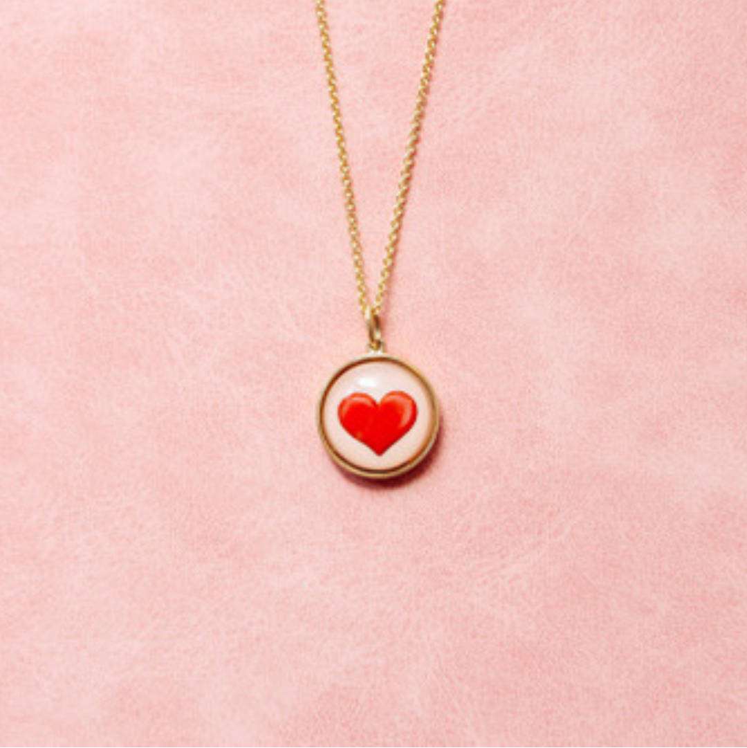 Necklace with a red heart pendant on a beige background