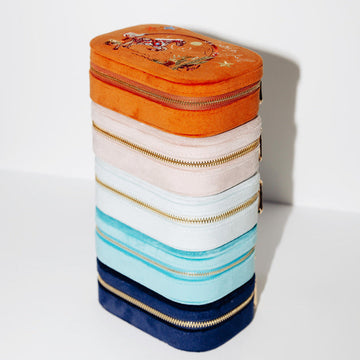 Stack of colorful jewelry boxes on a white background