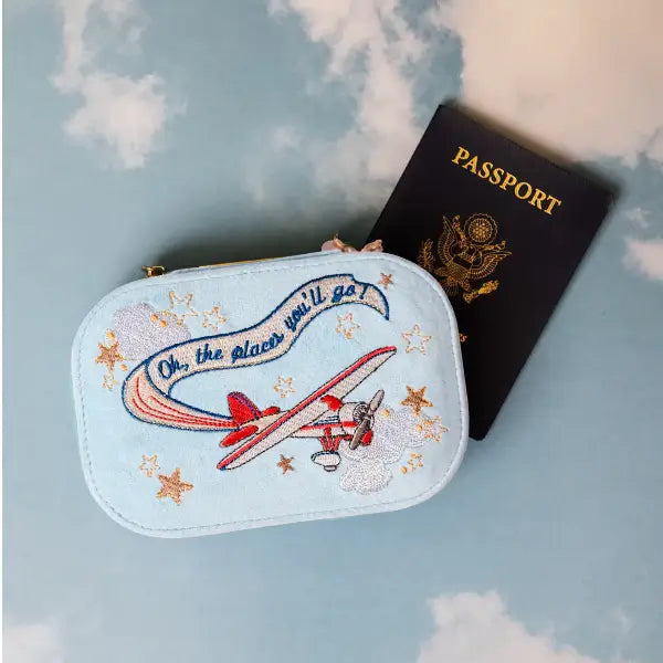 Embroidered velvet blue travel jewelry box with airplane design and 'Oh, the places you'll go' text.  Bon Voyage Light Blue Velvet Embroidered Travel Jewelry Box. Jewelry Dallas.