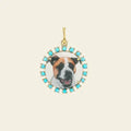 Dog pendant with turquoise stones on a beige background. Custom Pet Portrait. Hand-carved in Germany and painted in reverse intaglio on rock crystal, each charm is backed with luminous mother-of-pearl and set in your choice of 18K yellow, rose, or white gold. Jewelry Dallas.