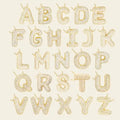 Gold alphabet letters on a beige background. Diamond Letter Pendant. Length and Layering: 16