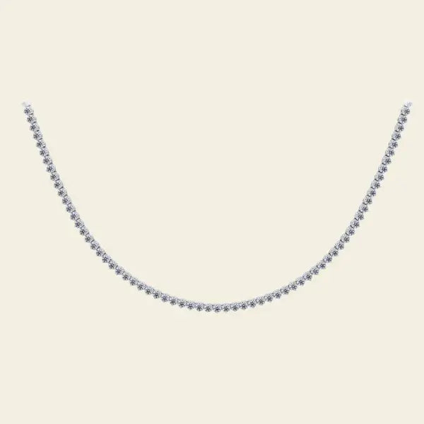 Diamond tennis necklace on a beige background. Diamond Tennis Necklace. Materials: Solid 14kt Gold with Natural Diamonds. Jewelry Dallas.
