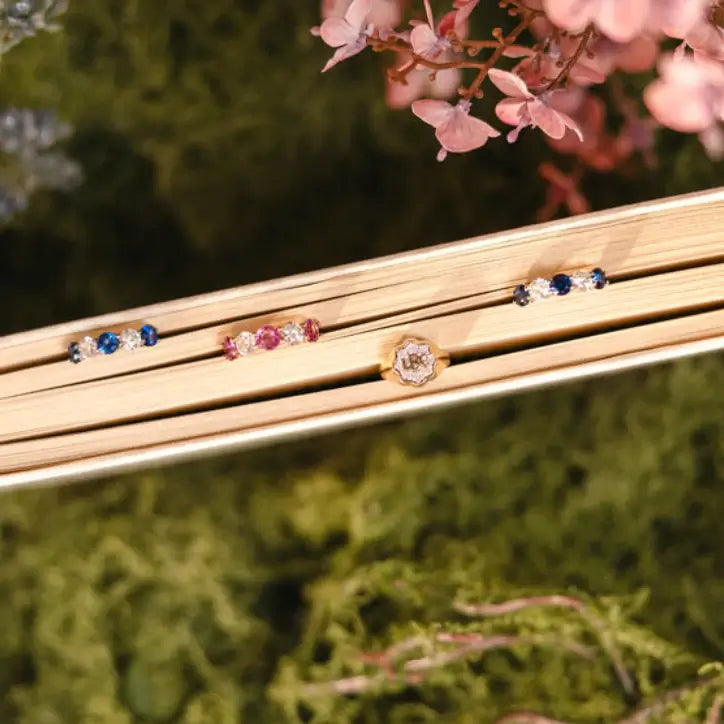 Ring with sapphires and diamonds in a book. Five Stone Blue Sapphire and Diamond Ring. # of Diamonds:2 Carat Weight:0.60 carat Shape:RoundColor:G-HClarity:SI1-SI2Cut:Excellent # of Sapphires:3Carat Weight:2.10 carats Shape:RoundColor:BlueClarity:Eye CleanCut:Excellent. 14k gold. Jewelry Dallas.