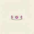 Gold ring with pink sapphires and diamonds on a beige background. Five Stone Pink Sapphire and Diamond Ring. # of Diamonds:2.5 Carat Weight:1.60 carats Shape:RoundColor:G-HClarity:SI1-SI2Cut:Excellent # of Sapphires:3Carat Weight:2.40 carats Shape:RoundColor:PinkClarity:Eye CleanCut:Excellent. Jewelry Dallas.