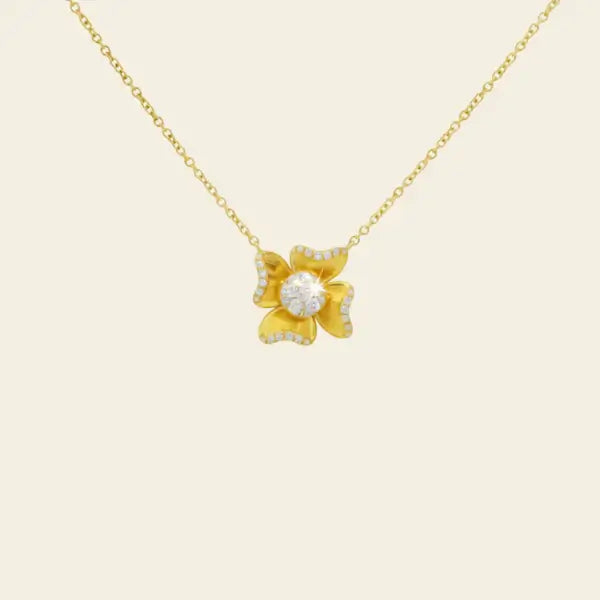 Gold necklace with a floral pendant on a beige background. Flower Power. Length: 16"+2" Link Chain Materials: Solid 14kt Gold with Natural Diamonds. Jewelry Dallas.