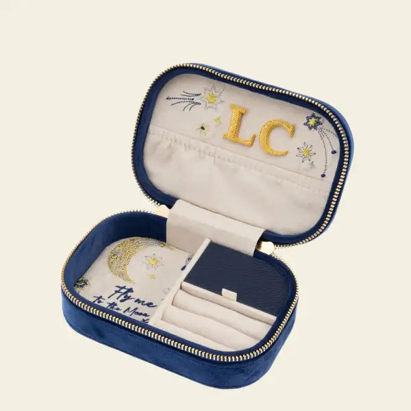 Blue velvet travel jewelry box with embroidered moon and stars, customized with initials. Fly Me to the Moon Navy Blue Velvet Embroidered Travel Jewelry Box. Jewelry Dallas.