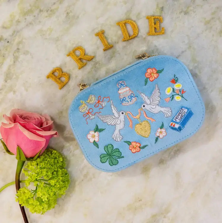 Embroidered travel jewelry box with birds, flowers, and a heart on a light blue velvet background, perfect for brides. Forever After Blue Velvet Embroidered Travel Jewelry Box. Jewelry Dallas.