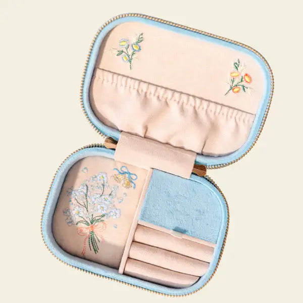 Embroidered travel jewelry box with birds, flowers, and a heart on a light blue velvet background, perfect for brides. Forever After Blue Velvet Embroidered Travel Jewelry Box. Jewelry Dallas.