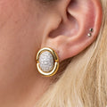Gold earrings with diamond-pave centers. Gold & Diamond Pavé Oval Earrings. These oval earrings are crafted in rich 14k yellow gold and set with 1 carat of natural pavé diamonds for radiant sparkle. Jewelry Dallas.