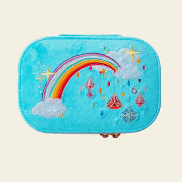 Blue velvet travel jewelry box with rainbow and cloud design on a beige background.  Jewels with Jules Velvet Embroidered Travel Jewelry Box. Jewelry Dallas.