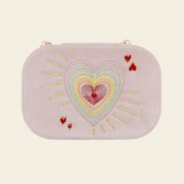 Pink travel jewelry box with embroidered heart design on a beige background. Love in the Air Light Pink Velvet Embroidered Travel Jewelry Box. Jewelry Dallas.