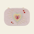 Pink travel jewelry box with embroidered heart design on a beige background. Love in the Air Light Pink Velvet Embroidered Travel Jewelry Box. Jewelry Dallas.