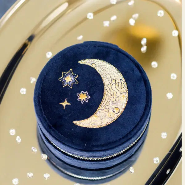 Round blue velvet mini travel jewelry box with embroidered moon and stars on a gold tray. Mini Fly Me to the Moon Navy Blue Velvet Travel Jewelry Box. Jewelry Dallas.