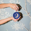 Round blue velvet mini travel jewelry box with embroidered moon and stars. Mini Fly Me to the Moon Navy Blue Velvet Travel Jewelry Box. Jewelry Dallas.