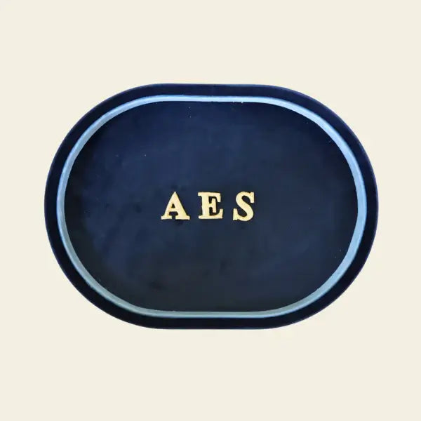 Navy blue velvet jewelry tray with 'AES' initials on a beige background. Navy Velvet Jewelry Tray. Jewelry Dallas.