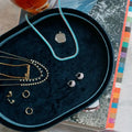 Jewelry set including necklaces and earrings on a dark blue velvet jewelry tray. Navy Velvet Jewelry Tray. Jewelry Dallas.