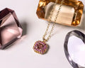 Gold necklace with a pink tourmaline gemstone pendant. One-of-a-Kind Pendant with Pink Tourmaline. The pendant is set in solid 14K gold with a blend of polished and subtly textured details that add richness and character. It hangs from a 3.2mm rolo chain. Jewelry Dallas.