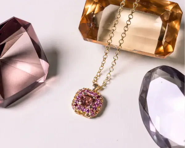 Gold necklace with a pink tourmaline gemstone pendant. One-of-a-Kind Pendant with Pink Tourmaline. The pendant is set in solid 14K gold with a blend of polished and subtly textured details that add richness and character. It hangs from a 3.2mm rolo chain. Jewelry Dallas.