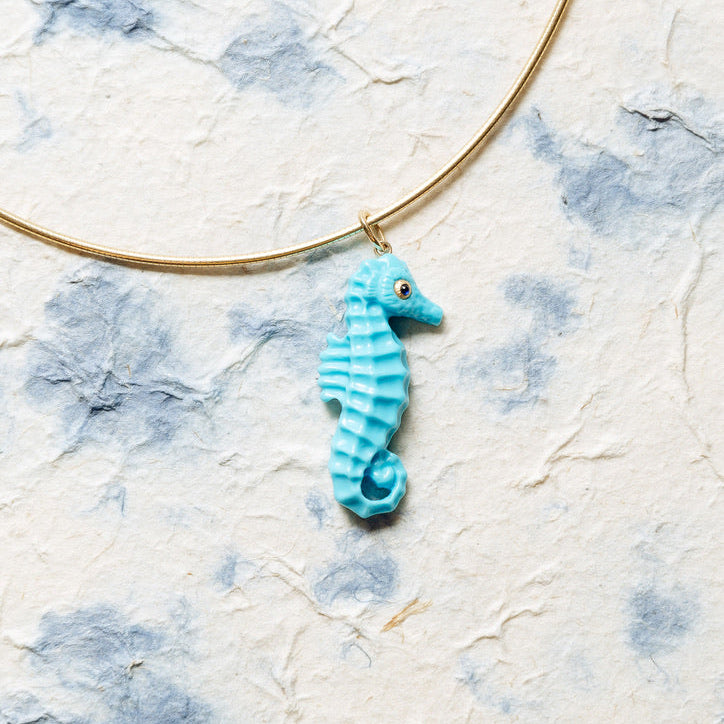 Seahorse pendant on blue and white background