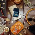 Collection of jewelry and accessories on a wooden surface. Spirit of Texas Burnt Orange Velvet Embroidered Travel Jewelry Box. Jewelry Dallas.
