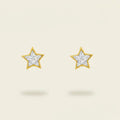 Star-shaped earrings with a gold setting and diamonds on a beige background. Star Studs. Materials: 18K Yellow Gold and Hand-Cut Natural Diamonds totaling 0.74 carats. Jewelry Dallas.