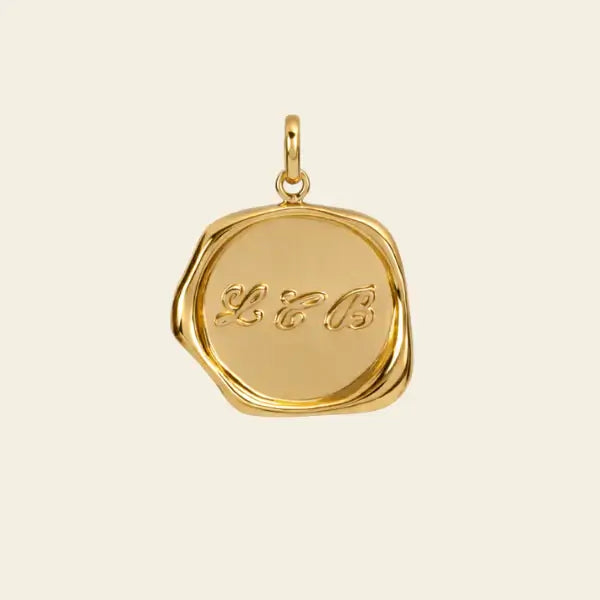 Gold pendant with initials on a beige background. Wax Seal Pendant Length: 16"+2" Link Chain
Material: 14kt Gold Over Sterling Silver .925 or solid 14kt Gold. Jewelry Dallas.