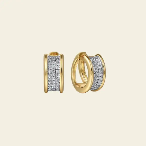 Gold hoop earrings with diamond accents on a beige background. Wide Diamond Huggies. Metal Type: 14k Yellow/white Gold Total Diamond Weight:0.60 ct
Average Diamond Clarity: SI or higher
Average Diamond Color: Near Colorless
Gemstone: Natural Diamond. Jewelry Dallas.